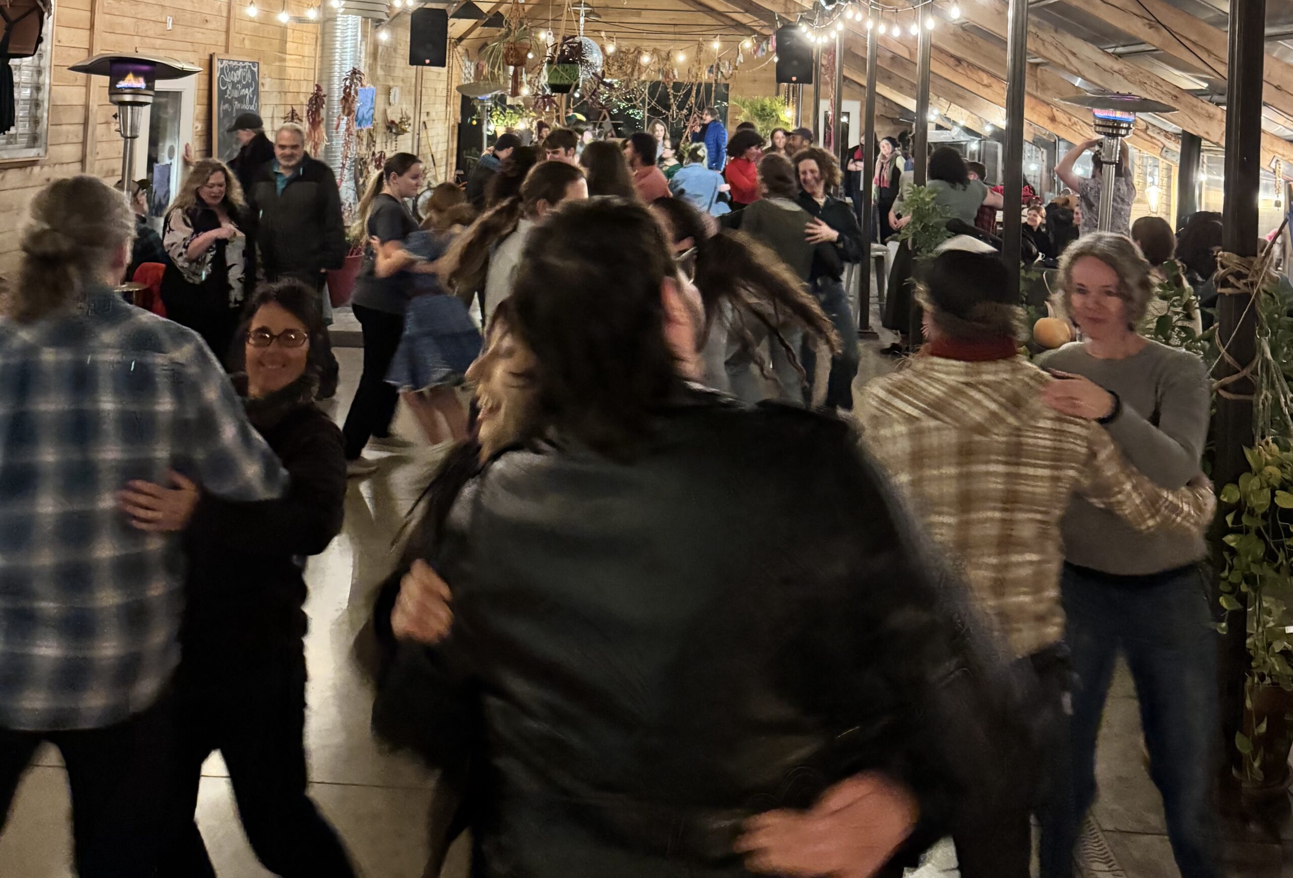 Ithaca High School choir students come together and enjoy a square dance.