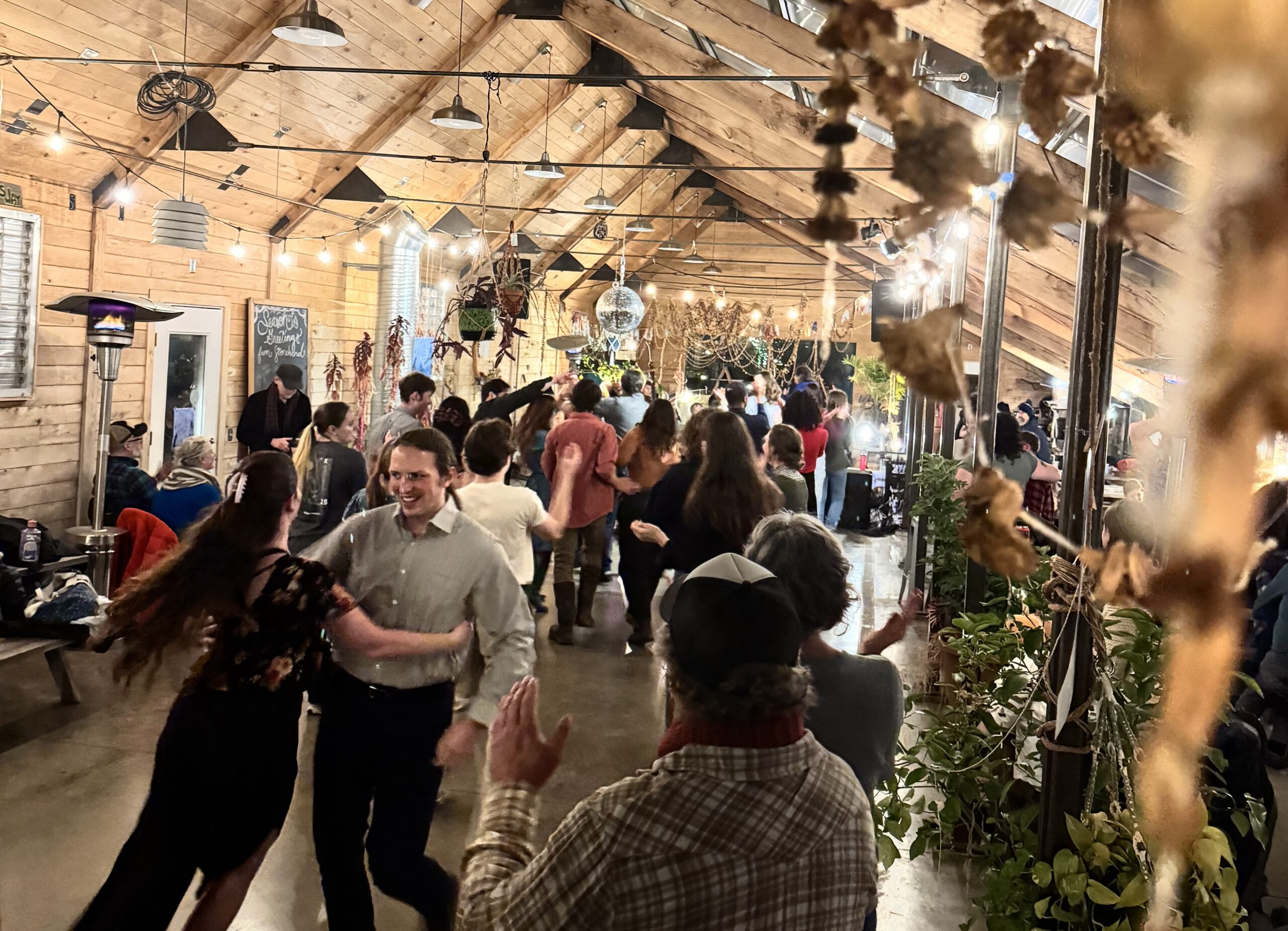 Enthusiastic dancers packed the greenhouse at Stone Bend Farm in Newfield for the 2025 Winter Solstice community square dance.